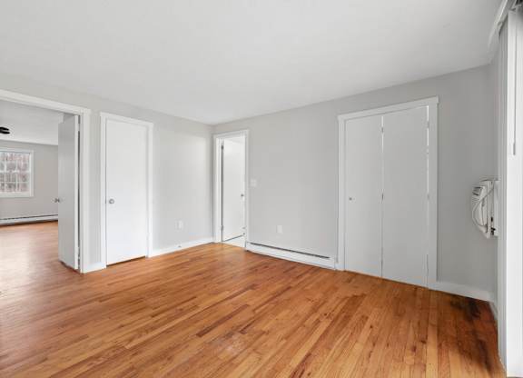 A room with wooden floors and white walls.