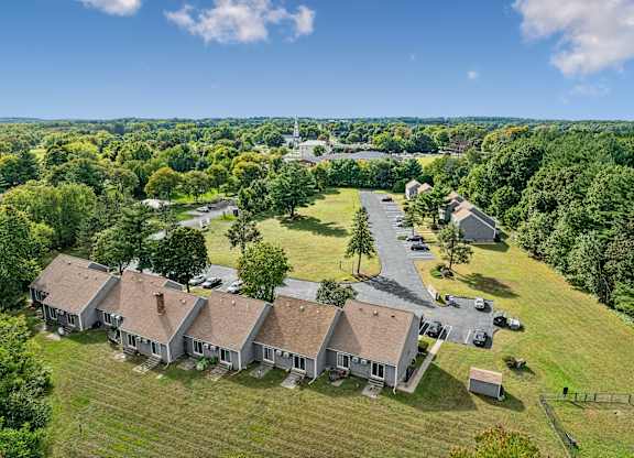 A bird's eye view of a residential area with buildings and cars.