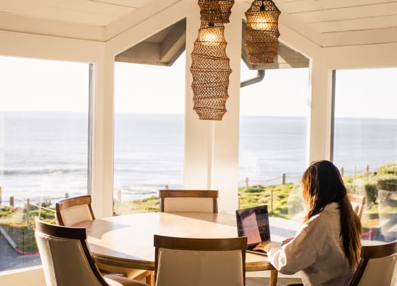 Woman working in the community room at Oceanaire