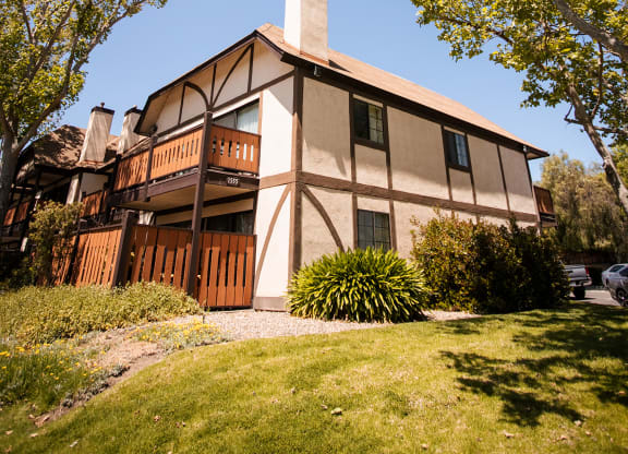 the side of a house with trees in front of it  at Oak Park Apartments, Solvang