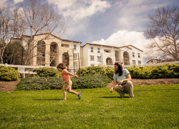 a woman playing with a child in a park at Arrive Temecula, California