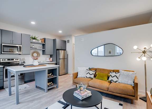 A modern kitchen with a dining table and a couch at Sora Apartments, Minneapolis, MN