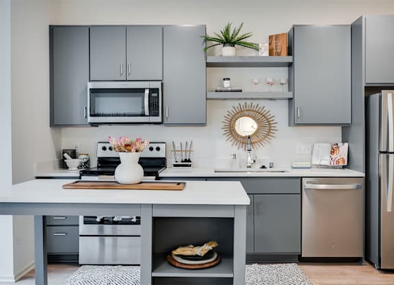 A modern kitchen with a grey cabinetry and stainless steel appliances at Sora Apartments, Minnesota, 55415