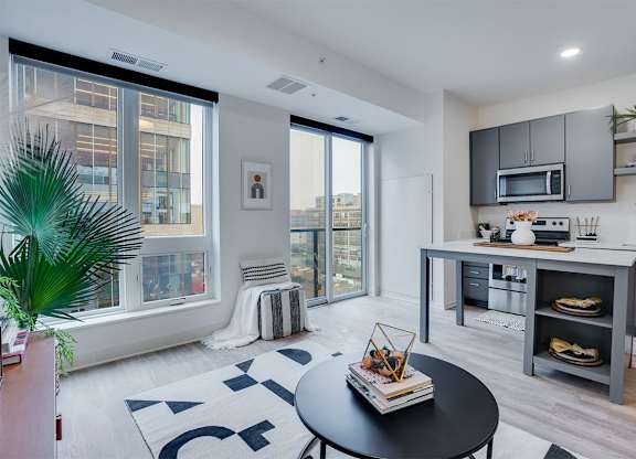 A modern kitchen with a black table and a framed picture on the wall. at Sora Apartments, Minneapolis, MN