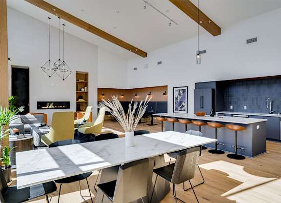 A modern kitchen with a dining table and chairs. at Sora Apartments, Minneapolis, Minnesota