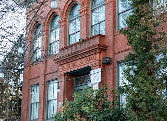 a large brick building with a sign in front of it