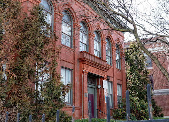 a red brick building with trees in front of it