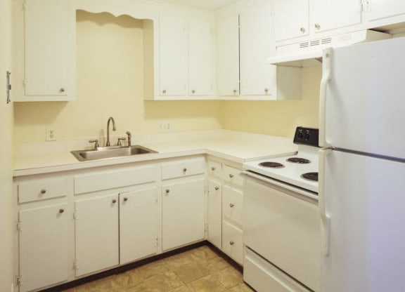 a kitchen with white appliances and white cabinets