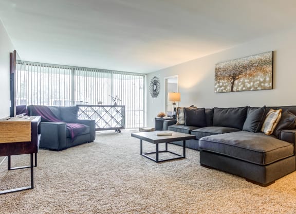 a living room with a couch and a chair at The Township at St. Charles, St. Charles, IL