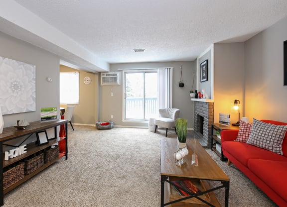 a living room with a red couch and a table