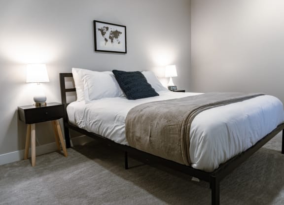 Bedroom with lamps at The Rowe, Grand Rapids, MI