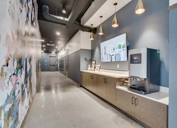 A long hallway with a wall of pictures on the left and a counter with a coffee maker on the right. at The Shale, Minnesota