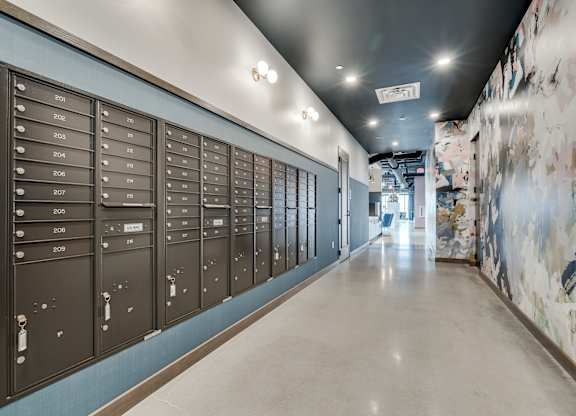 A long hallway with mailboxes on the wall. at The Shale, Minneapolis