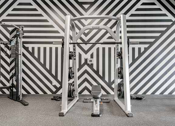 A gym with a weight bench and a squat rack. at The Shale, Minneapolis, 55406
