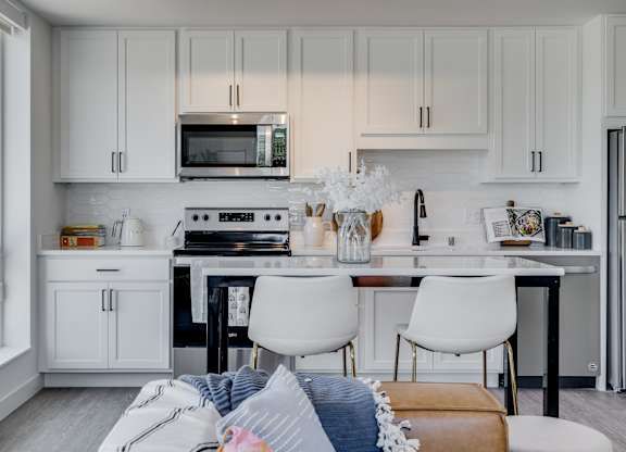 kitchen with white cabinets at The Shale, Minnesota, 55406