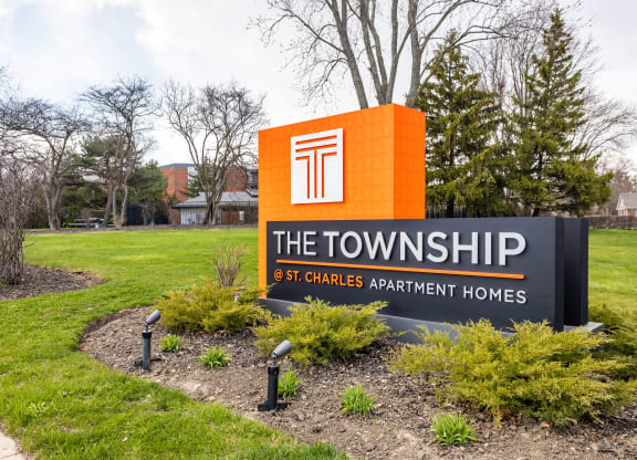 a sign that says the townships at the entrance to a lawn with trees in the backgroundat The Township at St. Charles, St. Charles, Illinois