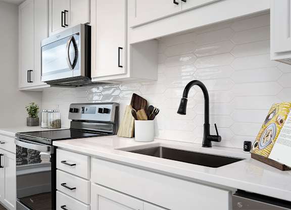 A modern kitchen with a black and white color scheme. at The Shale, Minnesota, 55406