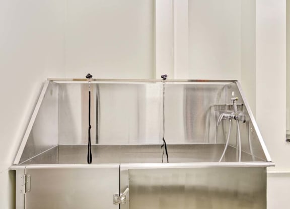 a large stainless steel tub sitting next to a wall at Flats at Southside, Pittsburgh, 15203
