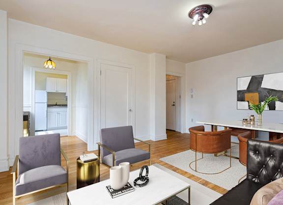 A living room with a white table and chairs.