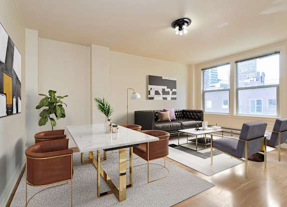 A modern living room with a white table and brown chairs.