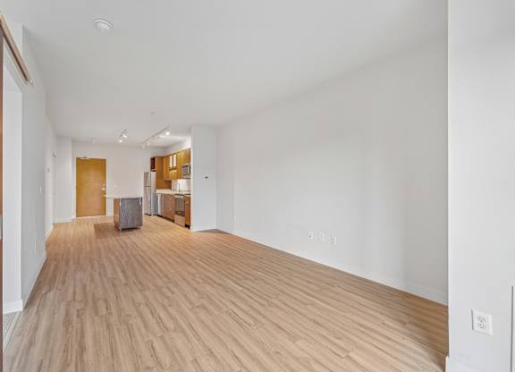A room with wooden floors and white walls.