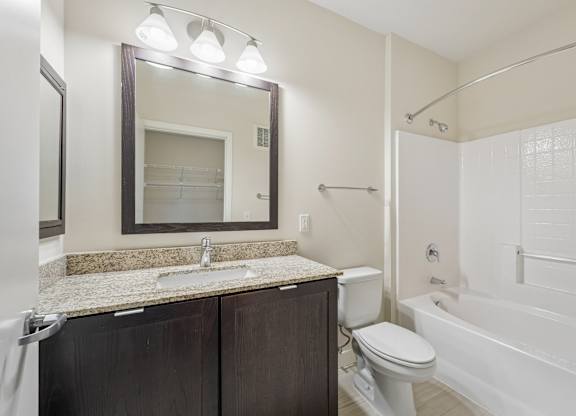 A bathroom with a sink, toilet, and bathtub.