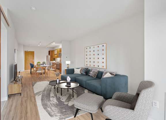 A living room with a blue couch and a television.