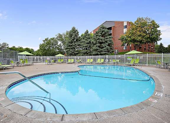 A round swimming pool with a blue water and a white line around it.