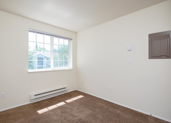 a white room with a window and a brown carpet at Murrayhill Park, Beaverton