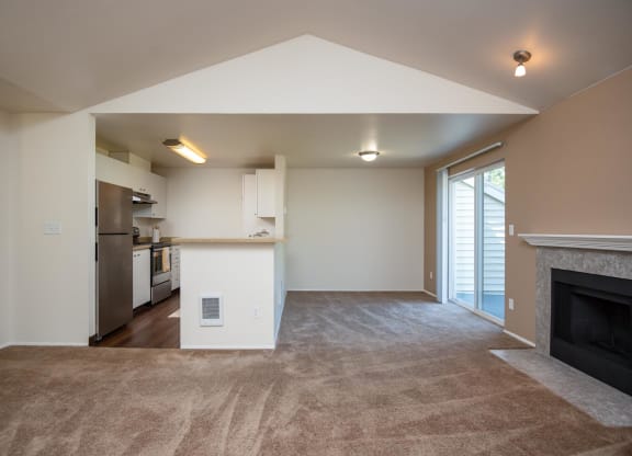 a living room with a fireplace and a kitchen at Murrayhill Park, Oregon