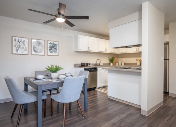 an open kitchen and dining room with a blue table and chairs at Sundial Apartments, Wilsonville Oregon
