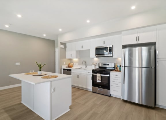 a kitchen with white cabinets and a stainless steel kitchen appliances at Arrive Temecula