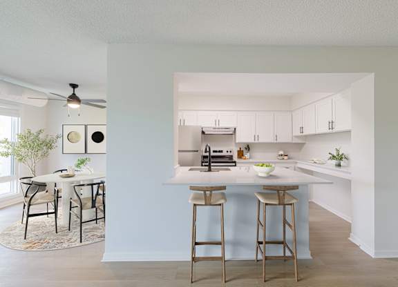 View of the kitchen with a bar area and a dining table.