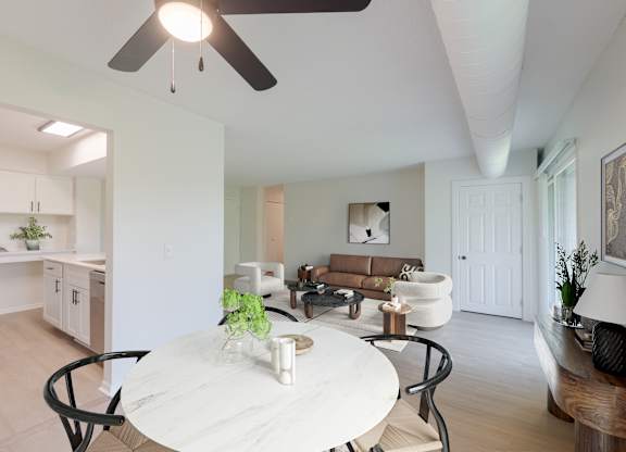 A modern dining room with a white table and chairs.