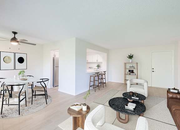 A living room with a white couch and a black coffee table.