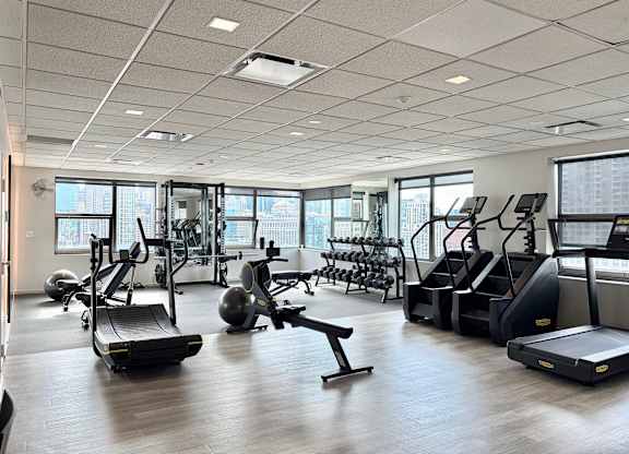 A gym with treadmills, exercise balls, and other equipment.