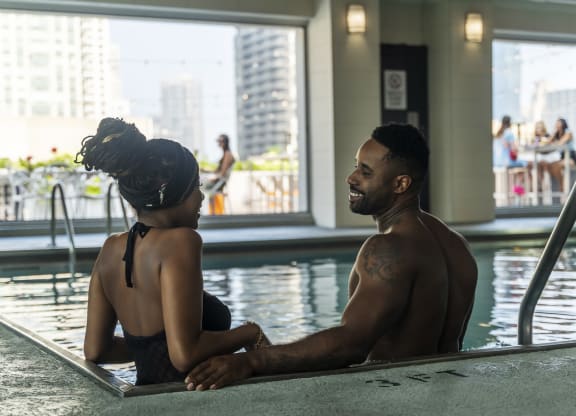 a man and a woman sit in a swimming pool at West77, Illinois, 60654