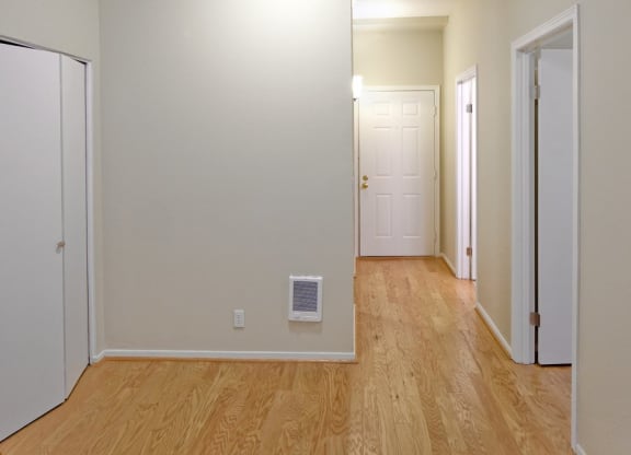 hallway with wooden floor and a white door