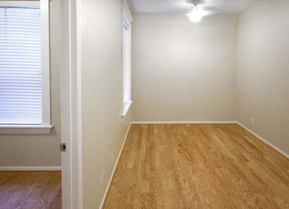 bedroom with wood flooring and a window