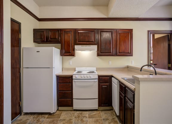 a kitchen with white appliances and dark wood cabinets at Whitney Gray, Portland, 97205 ?