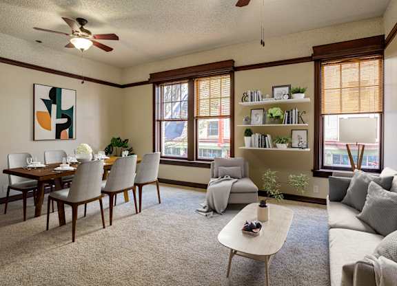 A living room with a dining table and chairs.