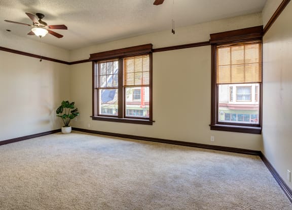 an empty living room with two windows and a ceiling fan at Whitney Gray, Oregon, 97205?