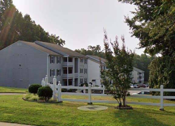 a white fence in front of a building at Woodgate, Charlottesville, 22901