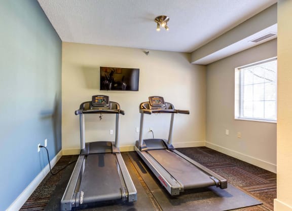 the treadmill area in the fitness room at the whispering winds apartments in pearland, tx