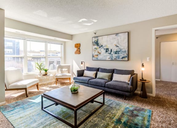 a living room with a large window and a couch