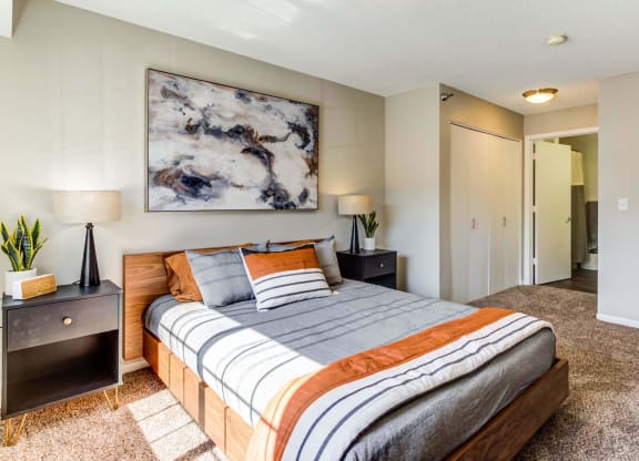 a bedroom with a bed and two night stands