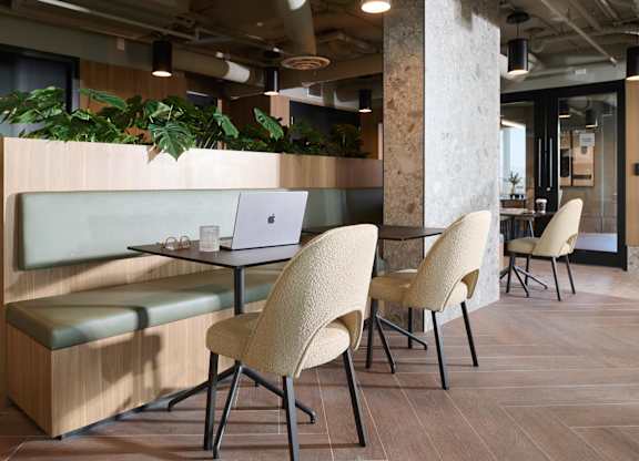 A modern office space with a wooden table and chairs.