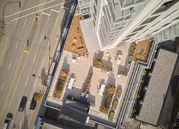 A view of a city street from above with cars and buildings.