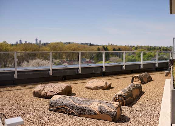 A balcony with a railing and a view of a city skyline.