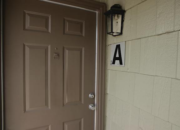 A brown door is on the left and a black lantern is on the right.